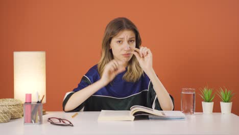 The-young-woman-making-the-small-sign-with-her-hand.