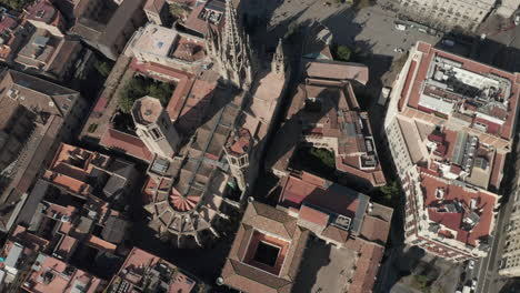 Top-down-footage-of-large-church-and-surrounding-buildings.-Cathedral-of-Barcelona-with-gothic-tower.-Barcelona,-Spain