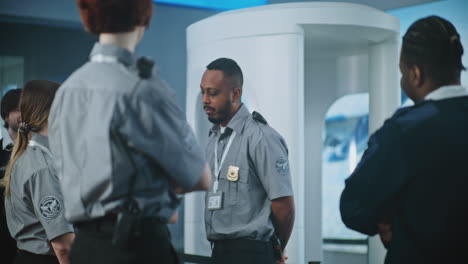 airport security personnel meeting at checkpoint