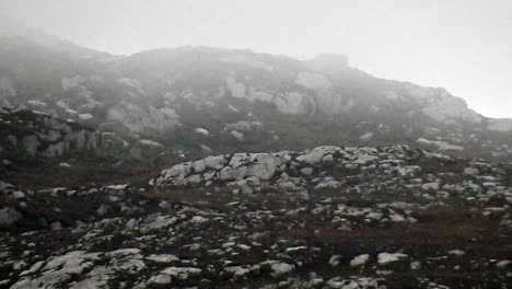 misty rain floating across rugged rocky mountain slopes on top of holyhead mountain north wales