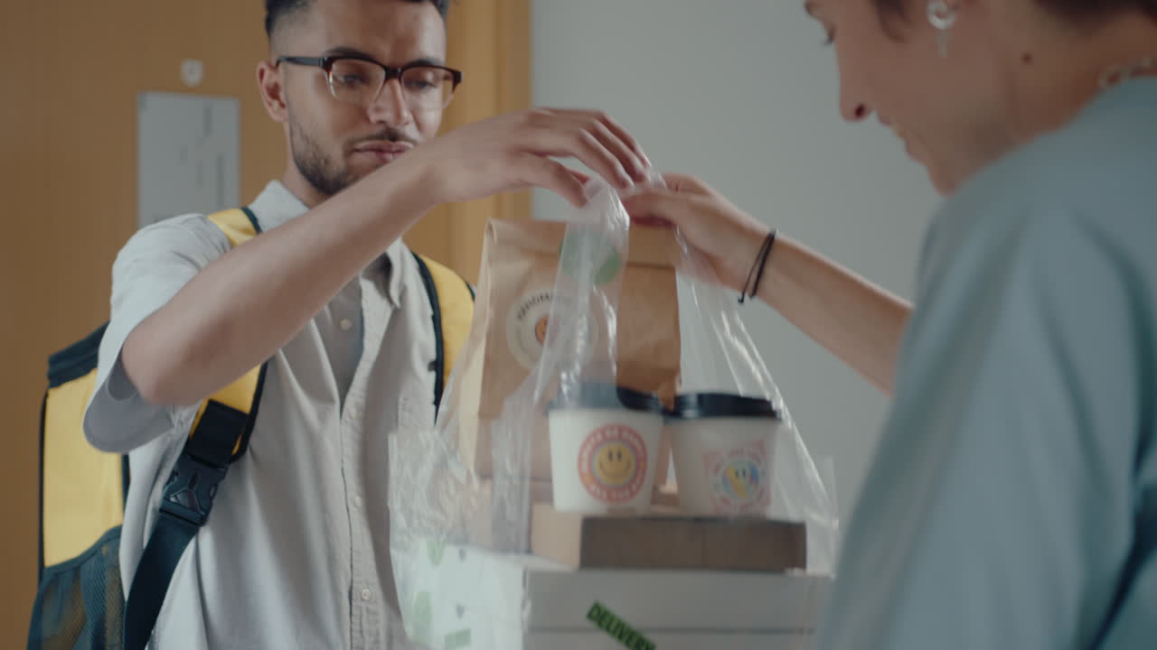 Courier Delivering Food and Drinks to Female Customer at Home
