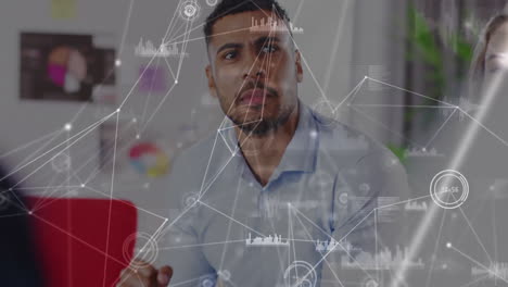 in office, businessman discussing data analytics with animation of digital network