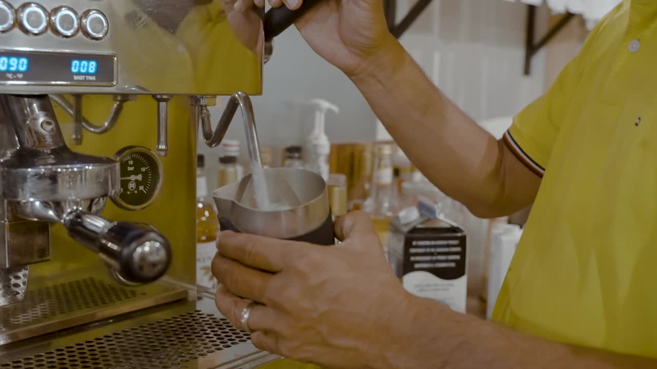 Coffee barista making a latte in a coffee shop