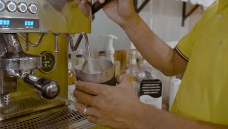 coffee barista making a latte in a coffee shop