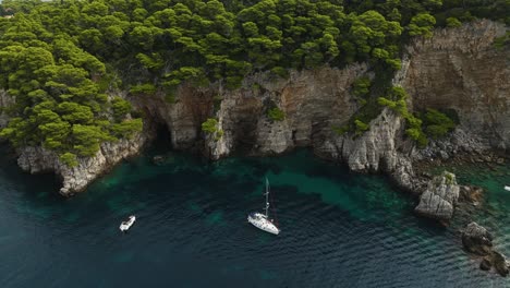 Sailboat-Near-Stunning-Kalamota-Island-With-Steep-Ragged-Cliffs-In-Adriatic-Sea,-Croatia