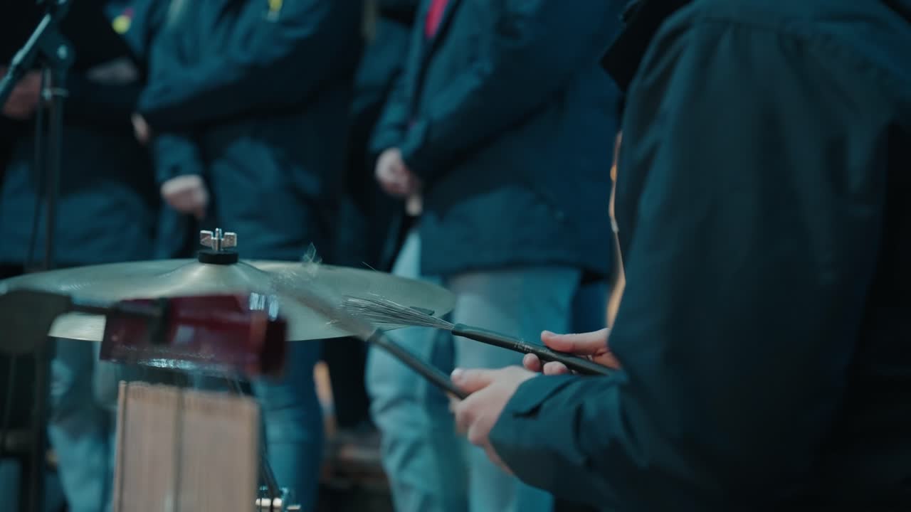 Close up of a drummer playing with wire brushes during a live performance