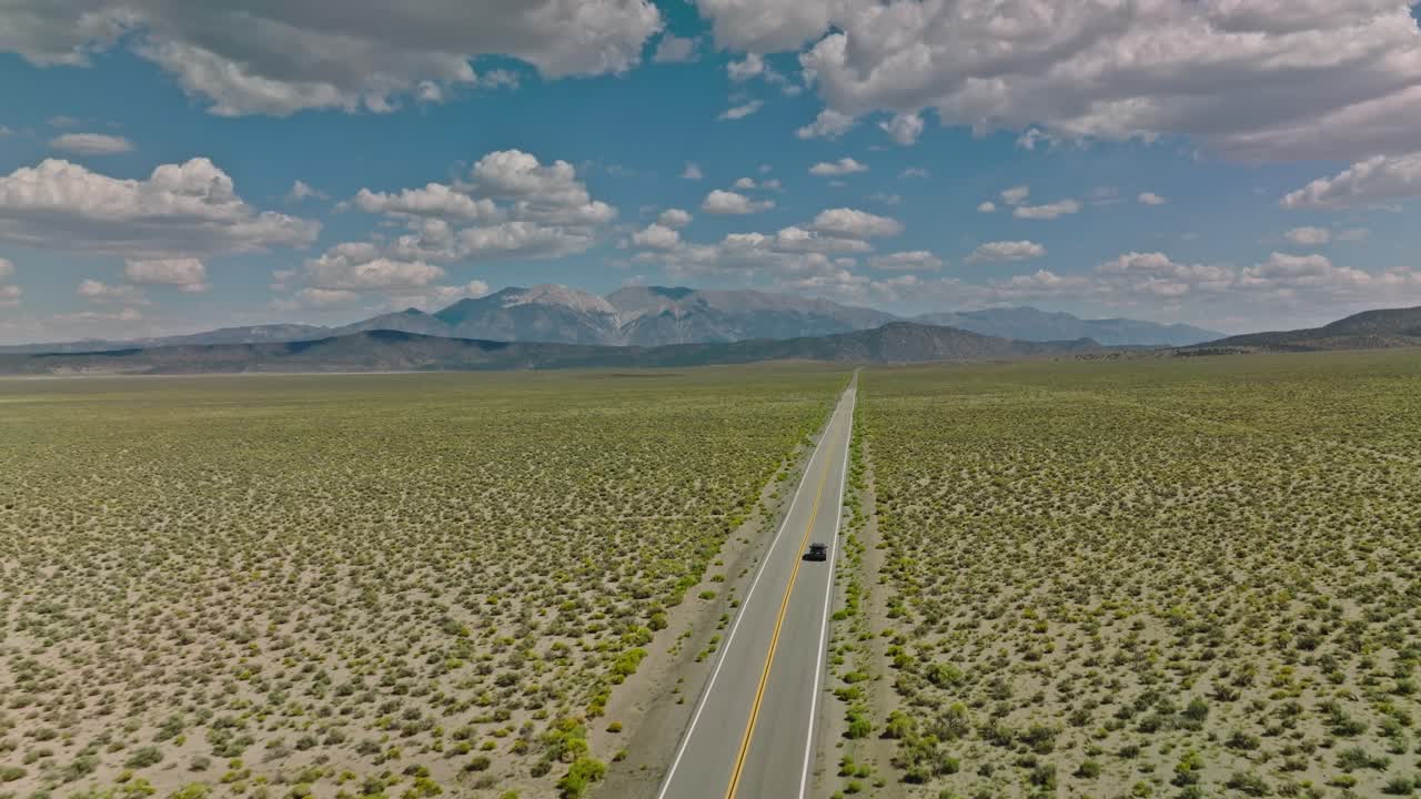 Car Driving Down a Nevada Desert Road