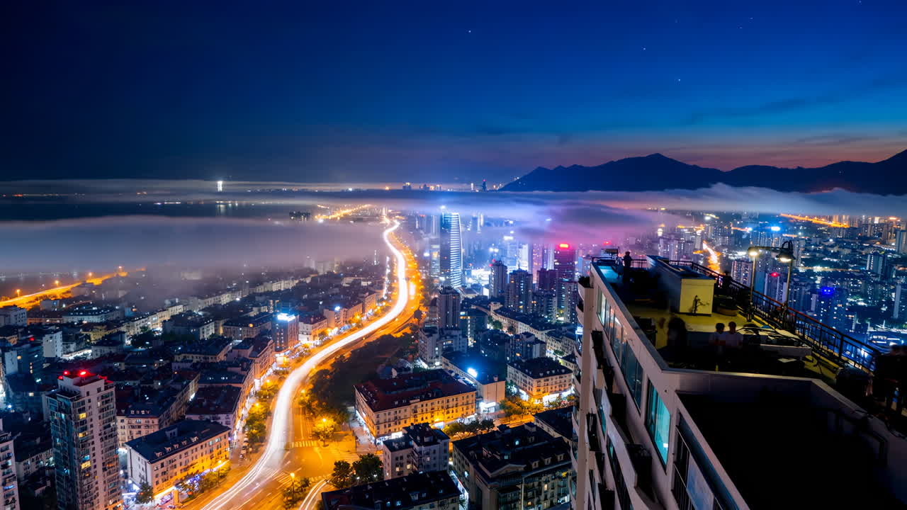 Nighttime cityscape with illuminated skyline and highway