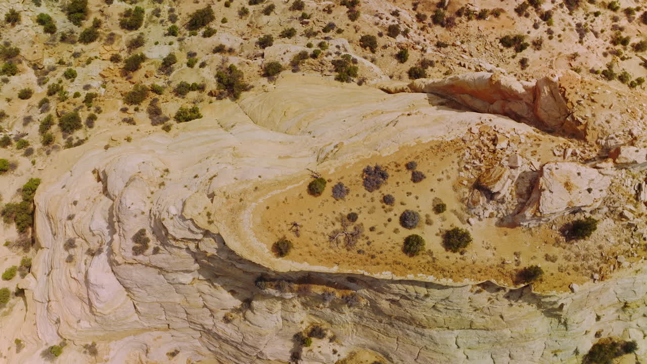 Dry and lifeless landscape of deserted territories in National Park of Utah, USA. Circle drone footage over the rock lit with bright hot sun.