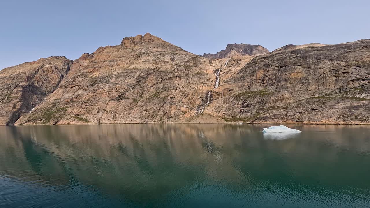 View of small iceberg and mountains in Prince Christian Sound in Greenland