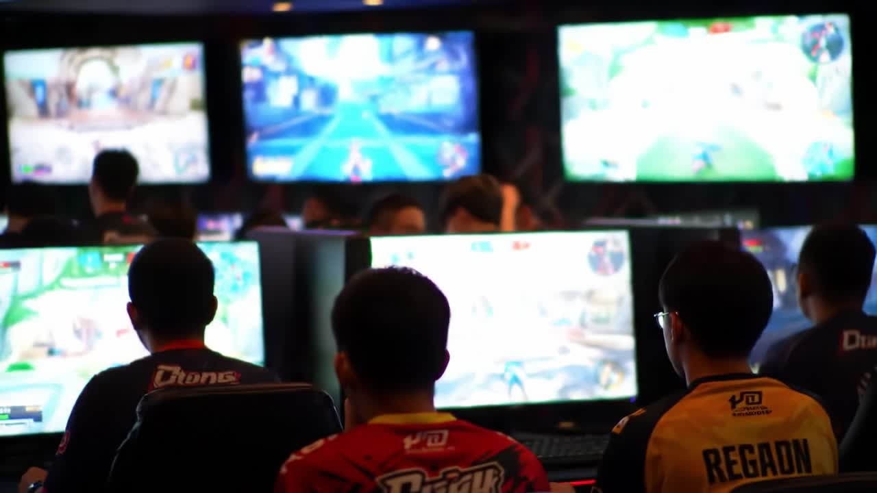 Competitive Gamers Engaged in Intense Play at an Esports Arena, Focused on Their Screens and Strategizing for Success in a Team-Based Online Game.