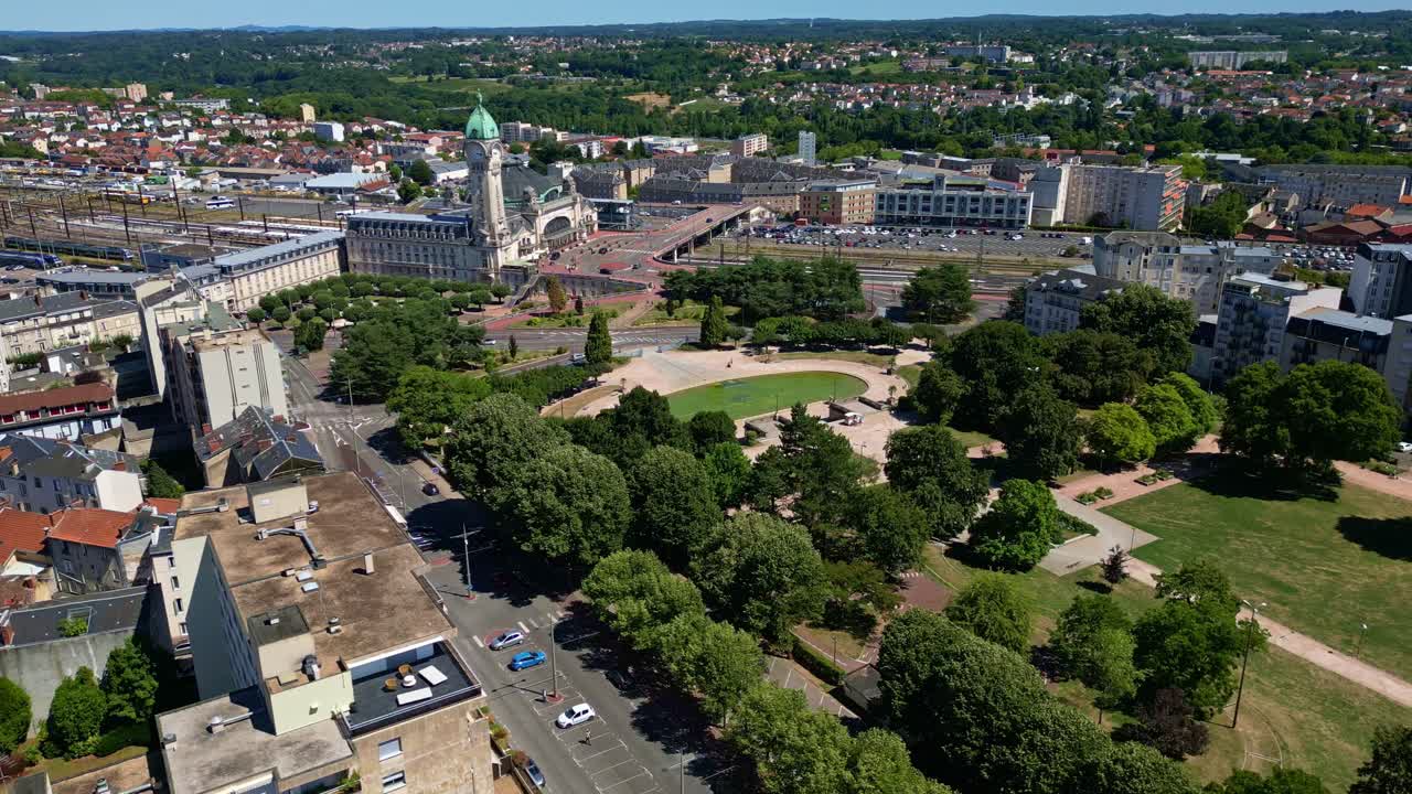 Panning panoramic drone fly at Champ de Juillet public park with the Limoges-Bénédictins railway station in background, Limoges, Haute-Vienne, France