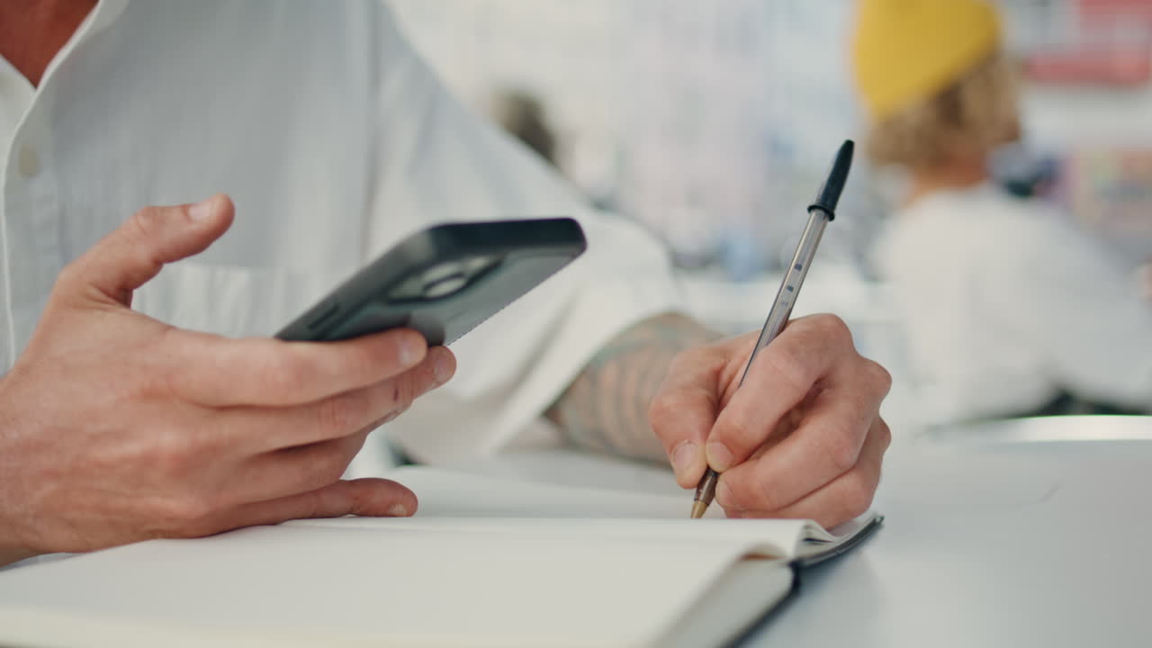 Man hand writing pen notebook at street cafe closeup. Businessman making notes