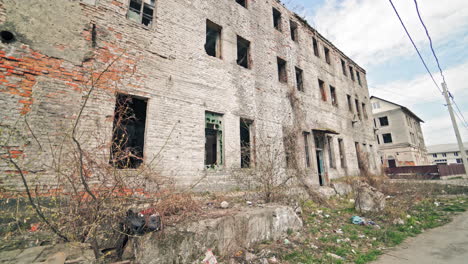old industrial building for demolition. large ruined abandoned factory hangar or warehouse.