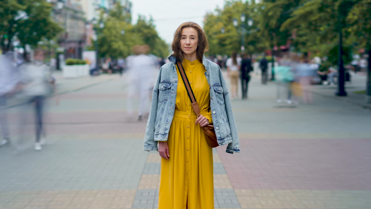 Woman in Yellow Dress and Denim Jacket on City Street