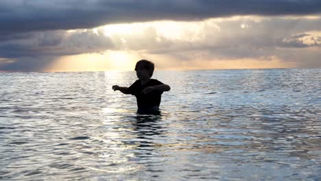 A-solitary-figure-walks-into-waves-of-a-breathtaking-Miami-Beach-sunrise