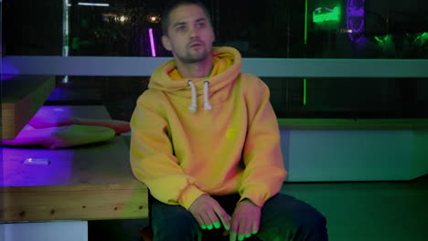 gamer in a neon lit gaming room