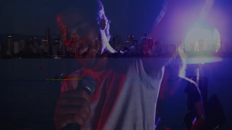 music bandmates singing into mic and playing guitar under red blue lights blending city skyline
