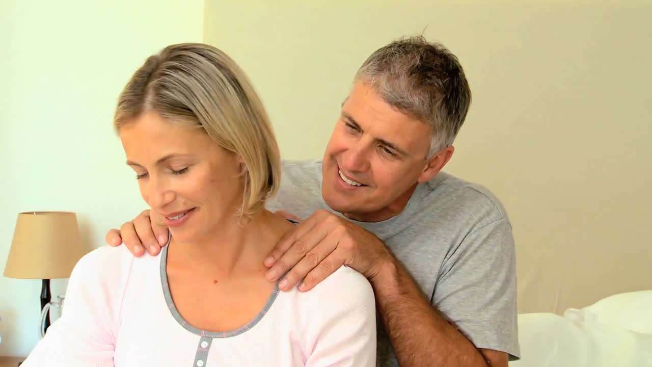 Man massaging his wifes shoulders