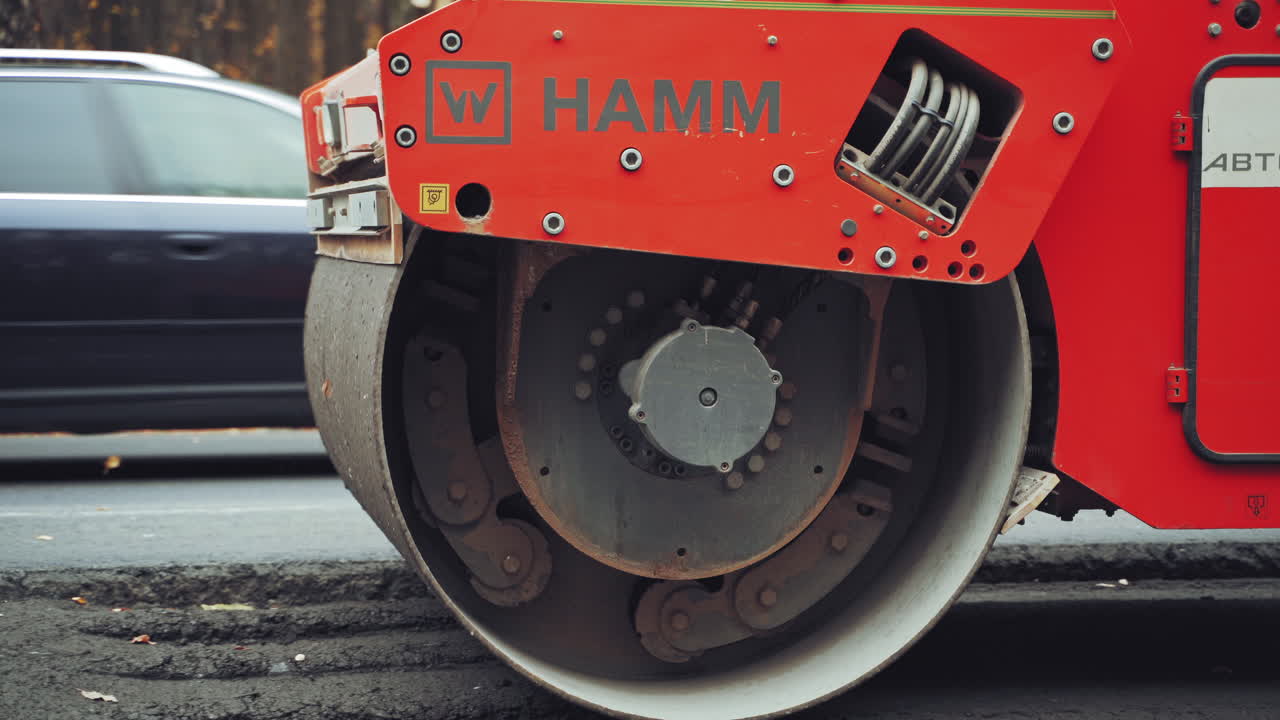 Road roller repairing asphalt pavement. Heavy vibration roller at asphalt pavement works