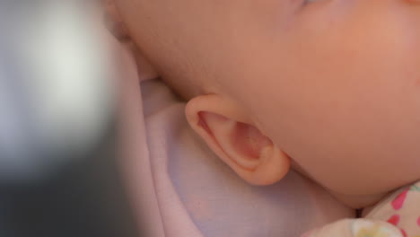 little baby girl lying in pram and moving