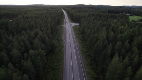 Aerial-View-Following-Lonely-Camping-Car,-Camper-on-a-Forest-Road-in-Northern-Finland,-Lapland,-Sunset
