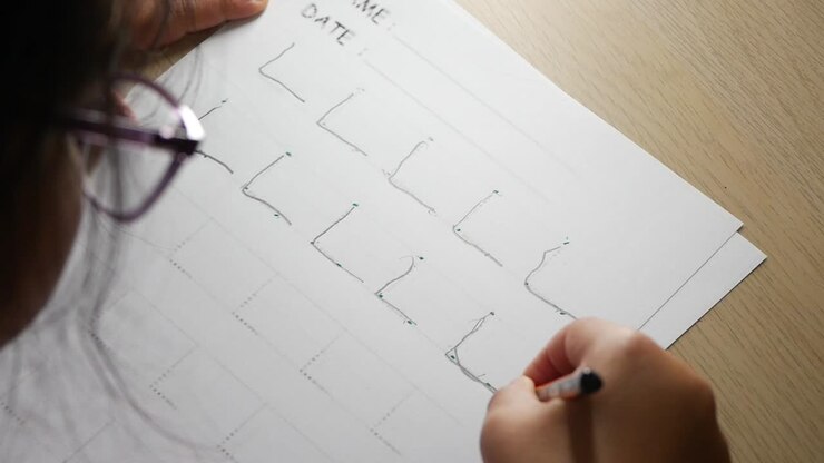 Close-up of a Child's Hand Learning to Write on Paper