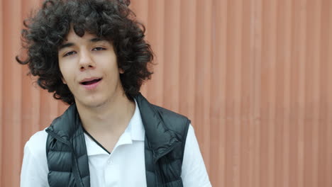 teenager with curly hair posing