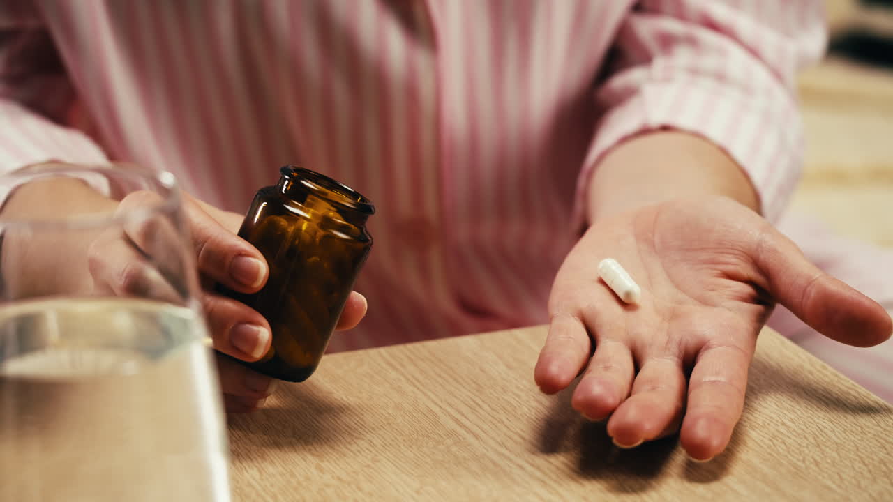 mujer tomando pastillas con agua