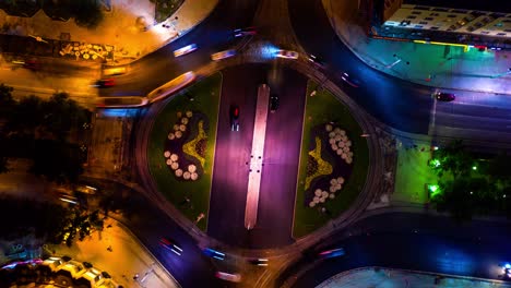 drone camera spin around crossroads night city. nightlife road with yellow light