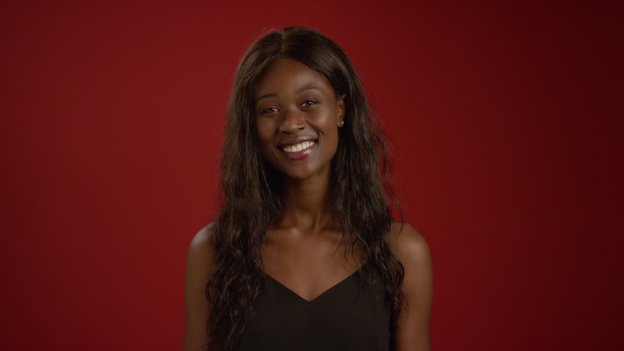 Smiling Young Woman Looks at Camera