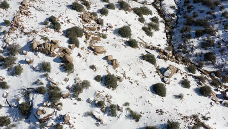 Drone-overhead-view-of-a-snow-covered-rocky-area-in-the-Gramote-Hills