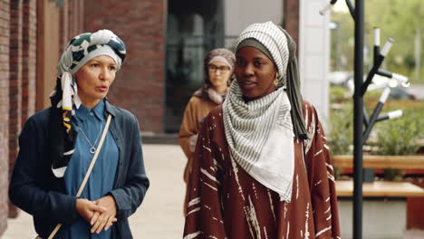 muslim women walking by building