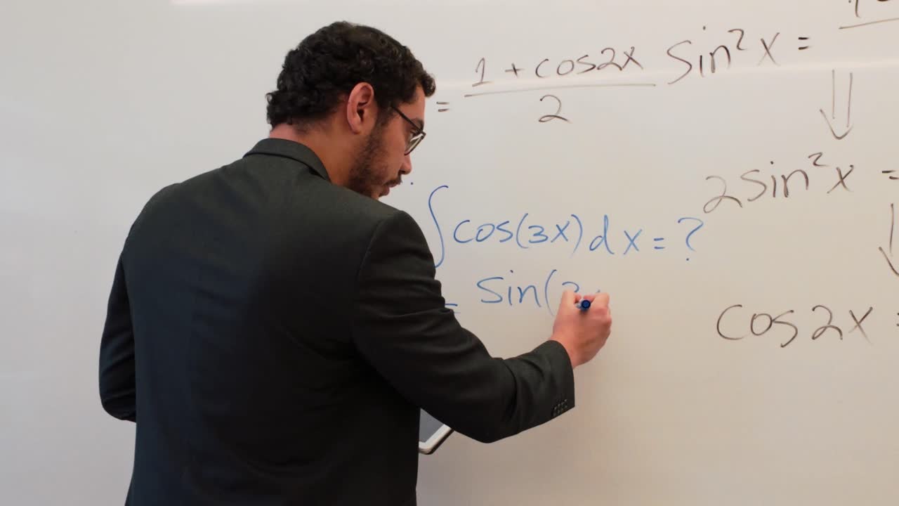 Man Writing Calculus Formulas in a Lecture Hall