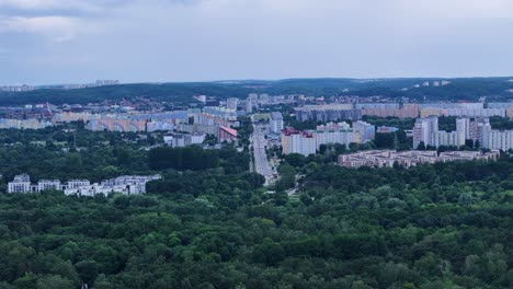 gdansk, poland, showcasing residential buildings, lush green forests, and a cloudy sky, capturing the urban landscape and natural beauty of the city, drone panning