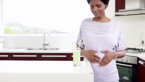 pregnant woman drinking smoothie