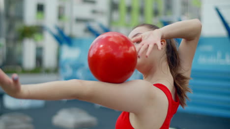 young woman practicing gymnastics outdoors