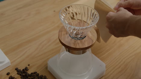 folding filter paper for brewing coffee, close up shot on tripod with no movement