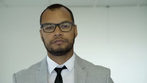 serious confident young man looking at camera