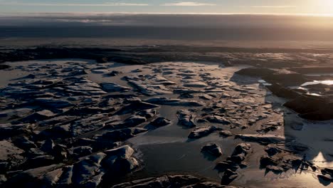 frozen lagoon haoldukvisl glacier in vatnajokull national park, iceland - drone shot