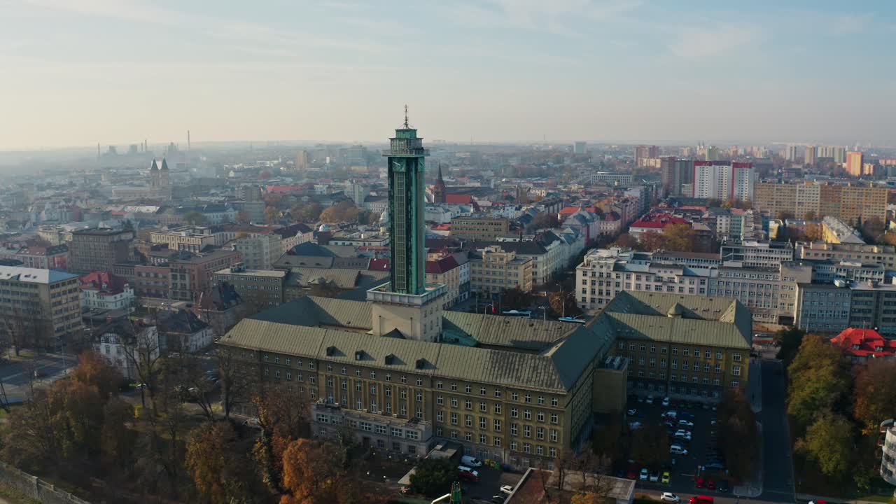 Side drone shot around ostrava city hall tower in summer