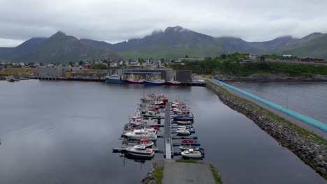 flying low over the harbor of husoy, aerial forwarding shot