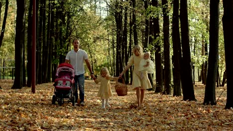 parents and children walk in the autumn park