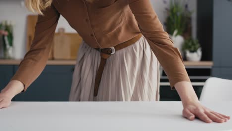 Caucasian-woman-laying-table-with-a-white-tablecloth.