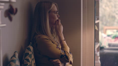 woman by the window daydreaming