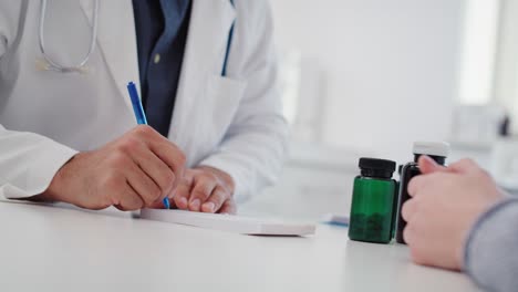 handheld view of doctor writing a prescription for his patient