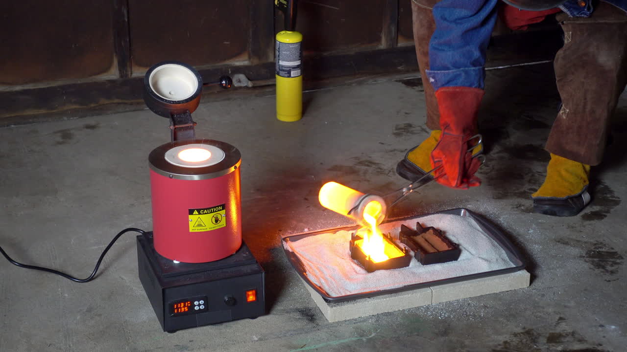 Crucible removed from furnace and molten metal poured into molds