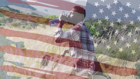 animation of american flag over african american man drinking water in mountains