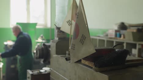 an employee at the metalworks factory prepares a machine for work