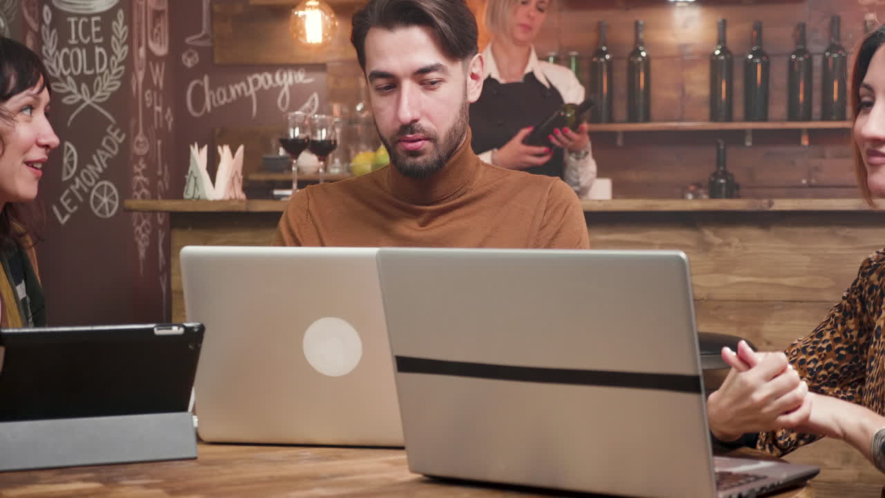People in a cafe using laptops
